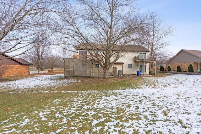 snow covered rear of property with a balcony