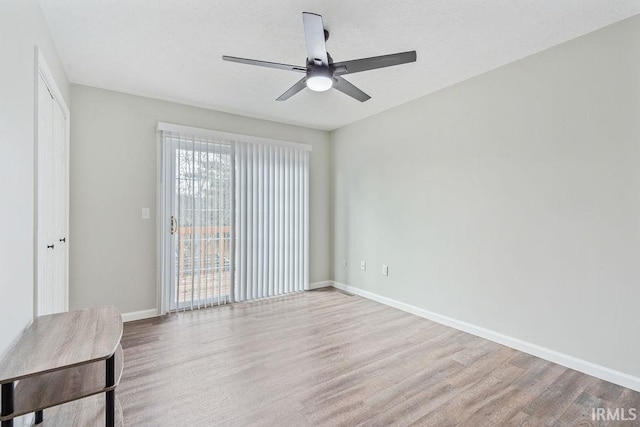 spare room with ceiling fan and light hardwood / wood-style floors