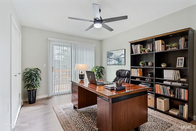 office space with ceiling fan and light wood-type flooring