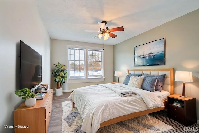 bedroom featuring hardwood / wood-style flooring and ceiling fan