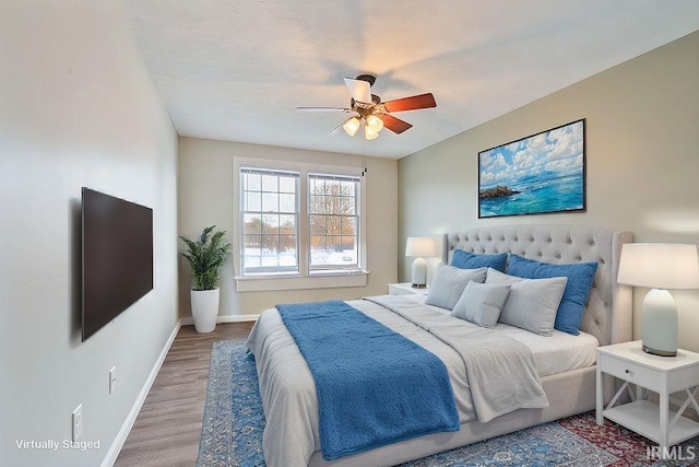 bedroom featuring hardwood / wood-style flooring and ceiling fan