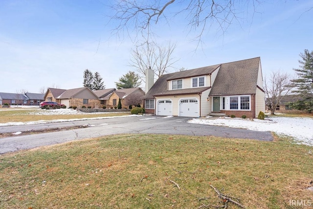 view of front of house featuring a garage and a front lawn