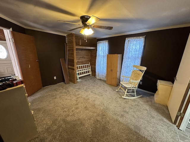 unfurnished bedroom with crown molding, ceiling fan, and carpet flooring