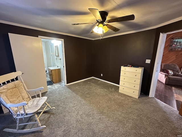 living area with crown molding, carpet, sink, and ceiling fan