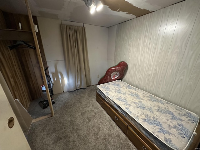 carpeted bedroom with wooden walls