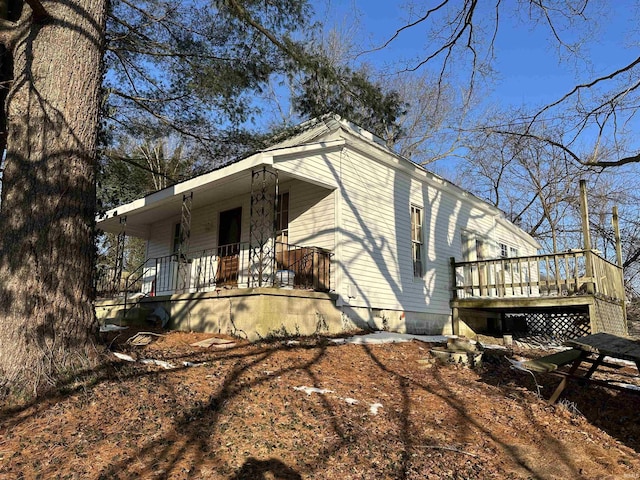 view of home's exterior featuring a deck and covered porch