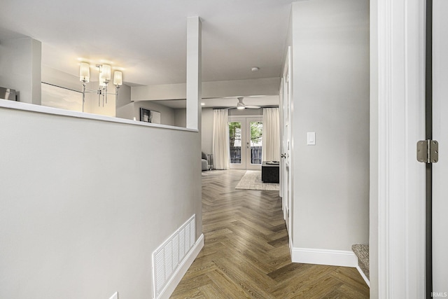 hall with parquet flooring and french doors