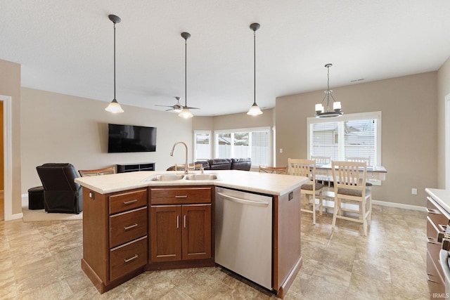 kitchen with sink, ceiling fan with notable chandelier, a center island with sink, decorative light fixtures, and stainless steel dishwasher