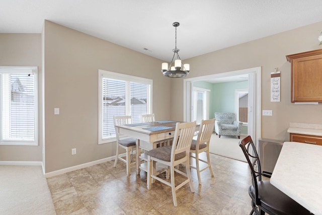 dining space featuring an inviting chandelier