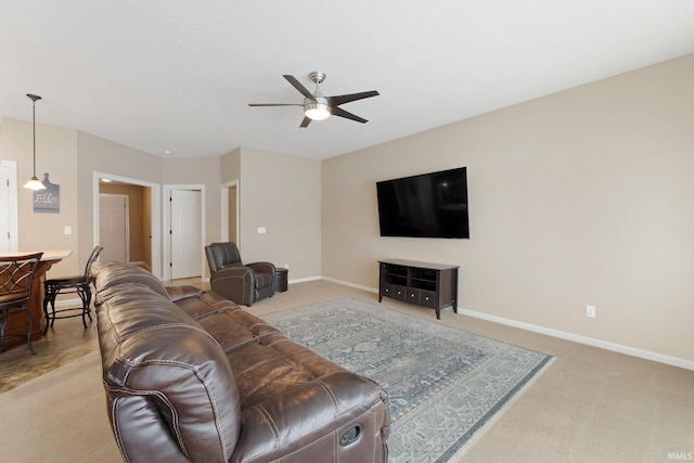 carpeted living room featuring ceiling fan