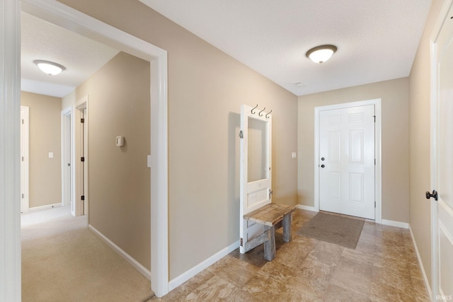 foyer entrance featuring a textured ceiling