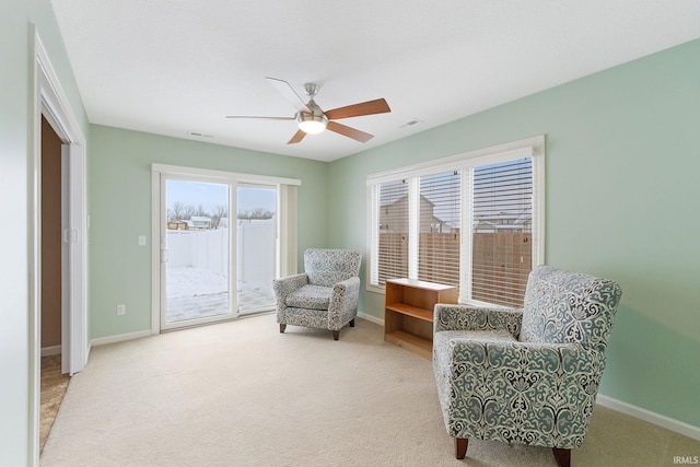 sitting room featuring carpet and ceiling fan