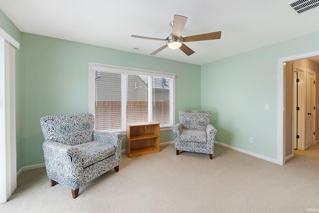 sitting room with carpet flooring and ceiling fan