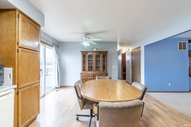 dining area with ceiling fan and light wood-type flooring