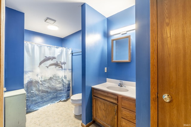 bathroom featuring vanity, toilet, and curtained shower