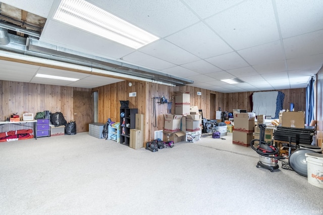 basement featuring carpet flooring and a paneled ceiling