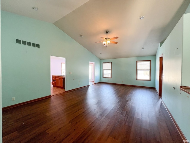 empty room with sink, high vaulted ceiling, dark hardwood / wood-style floors, and ceiling fan