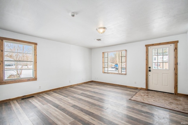 entrance foyer featuring visible vents, baseboards, and light wood-style floors