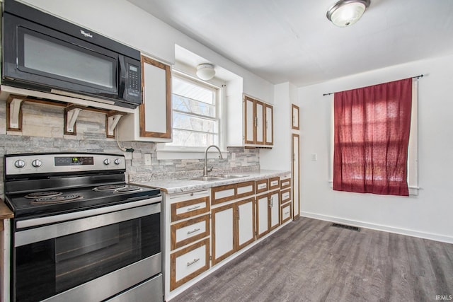 kitchen featuring electric stove, a sink, tasteful backsplash, black microwave, and dark wood-style flooring