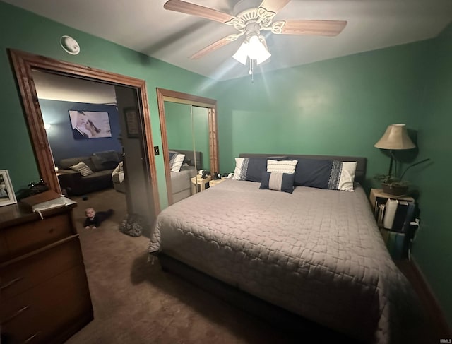 carpeted bedroom with ceiling fan and a closet