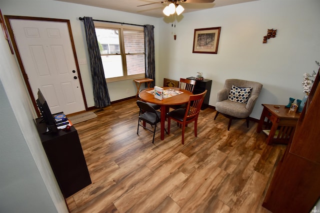 dining space with ceiling fan and dark hardwood / wood-style flooring