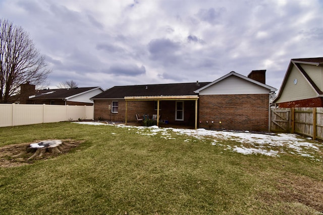 back of property featuring a lawn