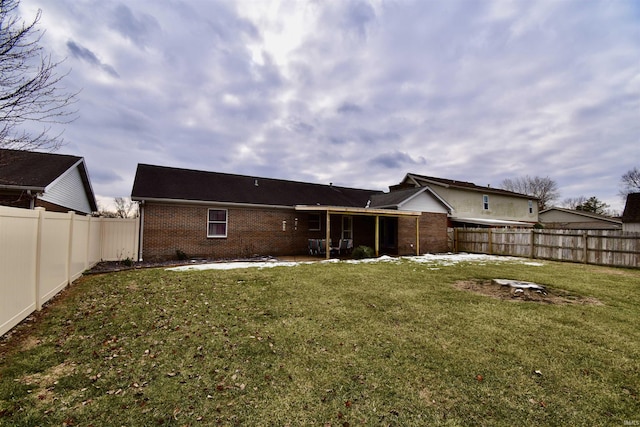 back of house with a yard and a patio