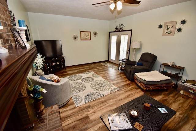 living room featuring ceiling fan and hardwood / wood-style floors