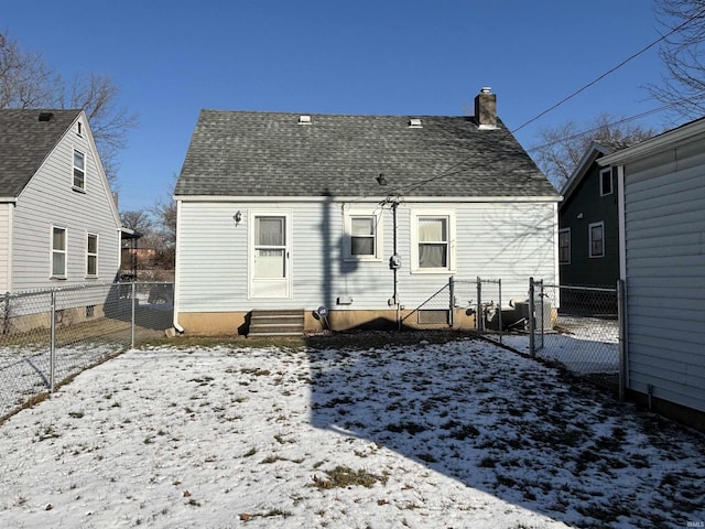 view of snow covered rear of property