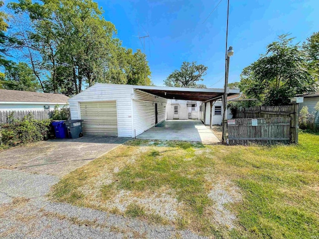 garage with a lawn and a carport