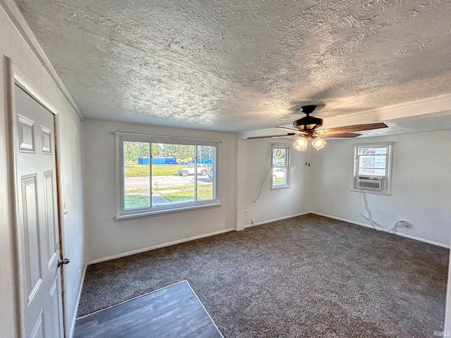 carpeted spare room featuring cooling unit, a textured ceiling, and ceiling fan