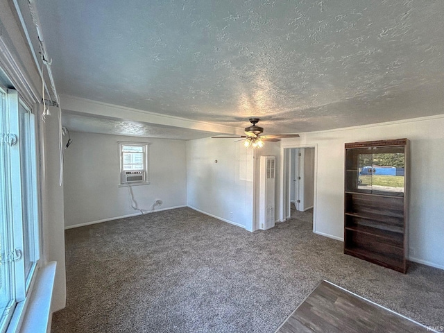 interior space featuring cooling unit, ceiling fan, carpet floors, and a textured ceiling