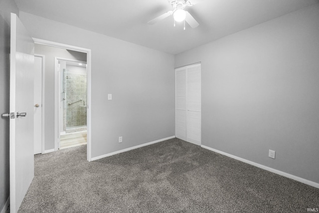 empty room with dark carpet and ceiling fan