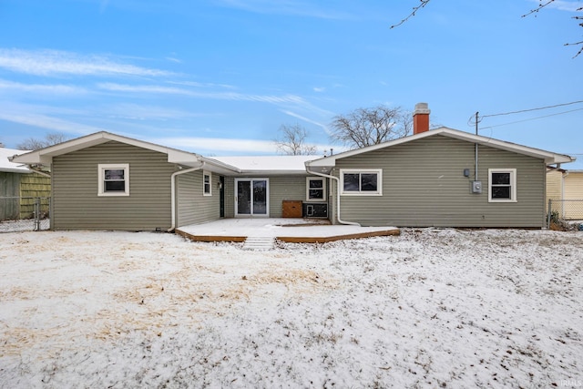 view of snow covered back of property