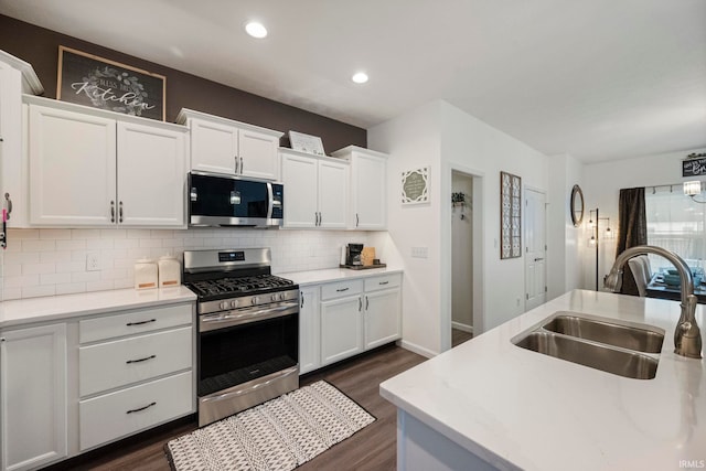 kitchen featuring white cabinetry, appliances with stainless steel finishes, light countertops, and a sink