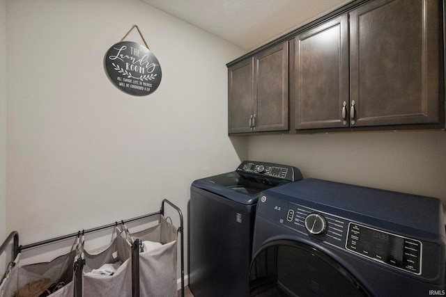 washroom with cabinet space and washer and clothes dryer