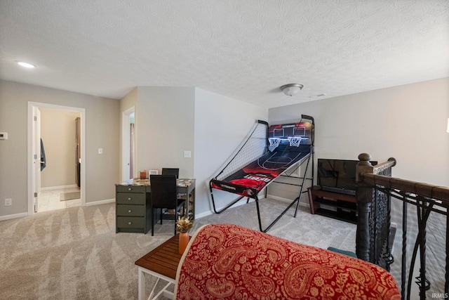 bedroom featuring light colored carpet, a textured ceiling, and baseboards