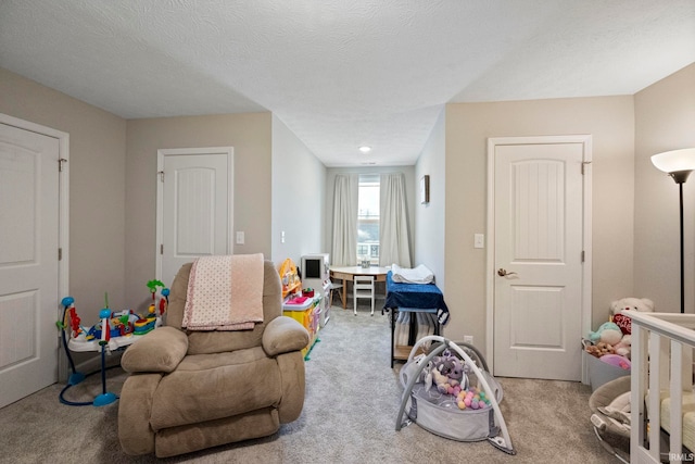 rec room with light carpet and a textured ceiling