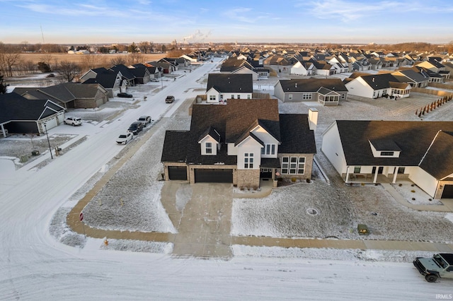 snowy aerial view featuring a residential view