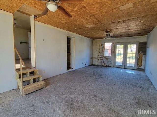 interior space featuring french doors, ceiling fan, and carpet flooring