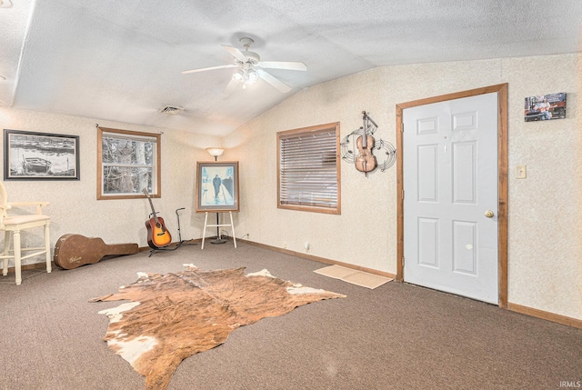 interior space featuring lofted ceiling, carpet floors, and ceiling fan