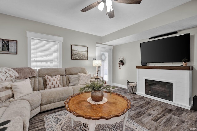 living room featuring dark hardwood / wood-style floors and ceiling fan