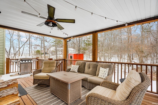 sunroom with ceiling fan and rail lighting