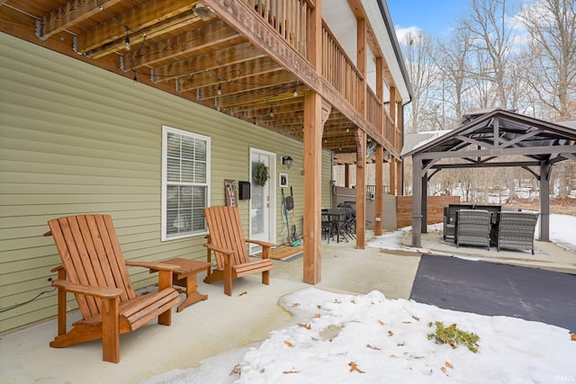 snow covered patio featuring a gazebo