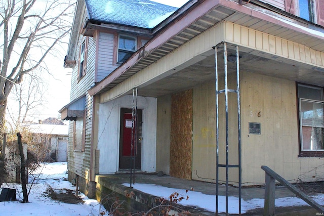 view of snow covered property entrance