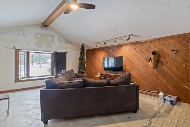 living room with vaulted ceiling with beams, wooden walls, a textured ceiling, and ceiling fan