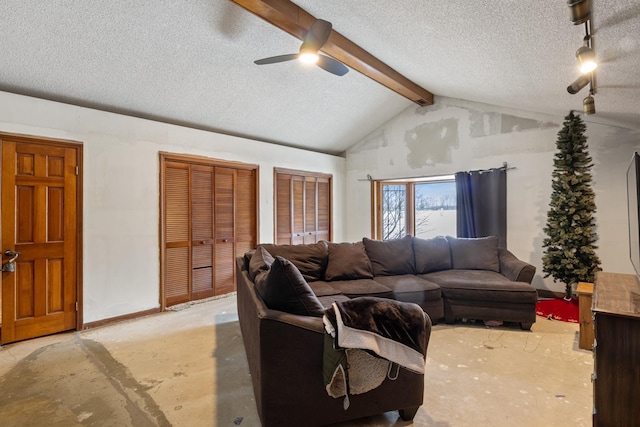 living room featuring lofted ceiling with beams, ceiling fan, and a textured ceiling