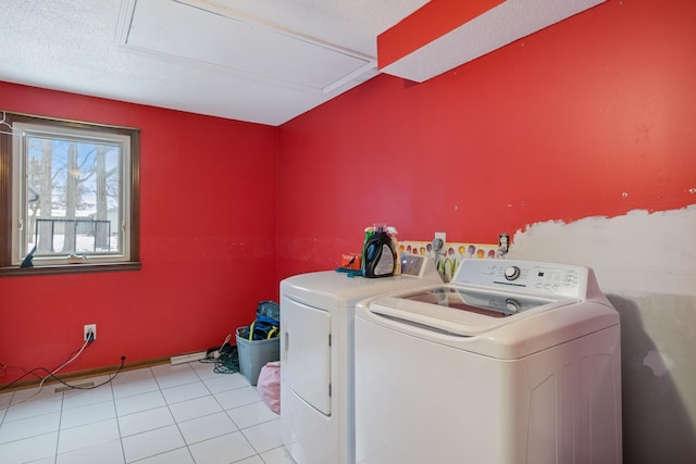 laundry room featuring light tile patterned flooring and washing machine and clothes dryer