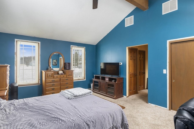 carpeted bedroom with vaulted ceiling with beams and ceiling fan