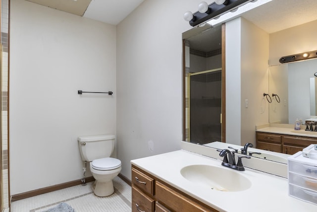 bathroom with an enclosed shower, vanity, tile patterned flooring, and toilet